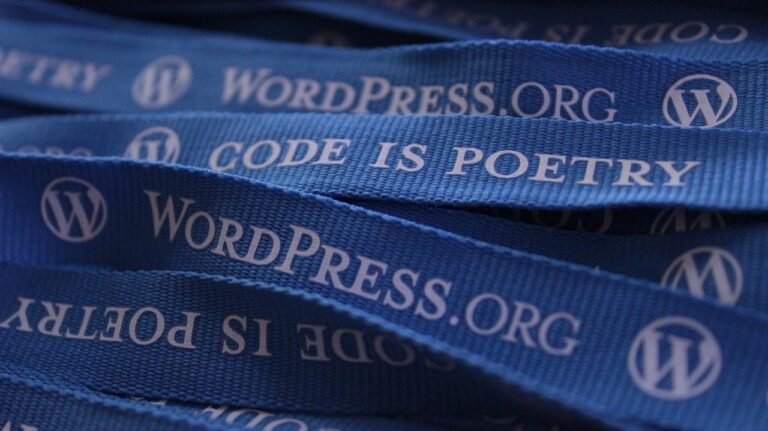 Blue lanyards featuring the text 'WordPress.org' and 'Code is Poetry'.
