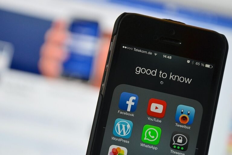 Smartphone displaying social media apps including Facebook, YouTube, and WhatsApp with the text 'good to know' on the screen.